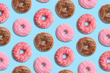 Colorful donut pattern on pastel blue background. Creative minimal summer concept.