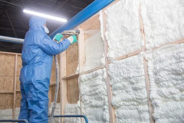 Fotobehang Insulation of walls with foam, energy and heat saving of walls, worker treats walls with foam © Anton