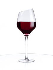 Red wine in a glass isolated on white background. Stylish wine glass with beveled edge