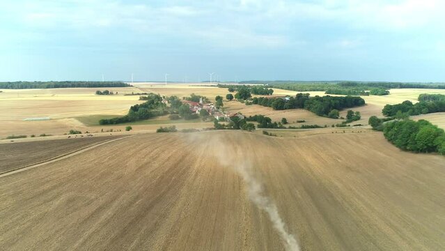 Tractor in Drought Struck Field, Leaving Dust Trail - Haute Marne, France 4K Drone Footage
