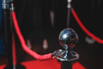 Red carpet with ropes and golden barriers on a luxury party entrance, cinema premiere film festival...