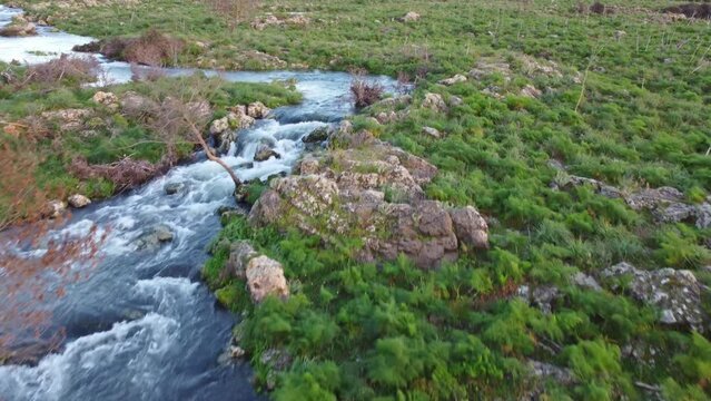 A seasonal river flows under the massive snowcovered Etna volcano. Favare Santa Venera