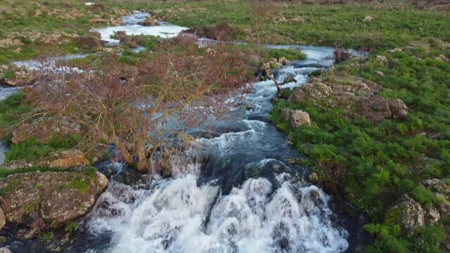 A seasonal river flows under the massive snowcovered Etna volcano. Favare Santa Venera