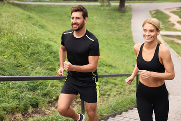 Healthy lifestyle. Happy couple running up stairs outdoors