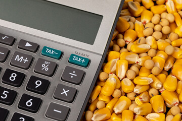 Tax calculator with corn and soybeans. Farm income, agriculture sales and property taxes concept