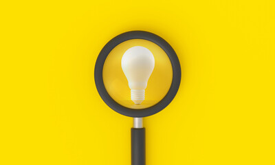 Magnifying glass looking to light bulb on yellow background.
