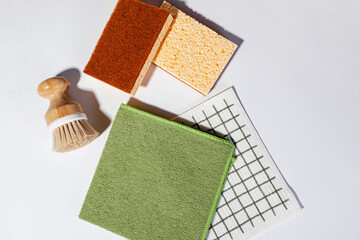 Modern cleaning supplies, dishcloth,brush and sponges, top view.