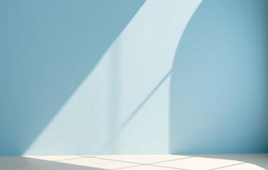 Sunlight casting soft shadows on a minimalist light blue interior wall.