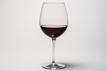 A single elegant wine glass filled with red wine, set against a white backdrop, offering a refined and easily cut-out image for use in beverage and celebration visuals.