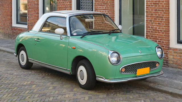 A light green Nissan Figaro in a street in the Netherlands. Only 12000 Nissan Figaro's were produced in Japan.