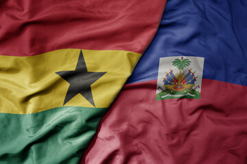 big waving national colorful flag of haiti and national flag of ghana .