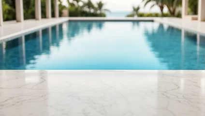 Fotobehang empty white marble table with blurry swimming pool background, backdrop with copy space © adynue