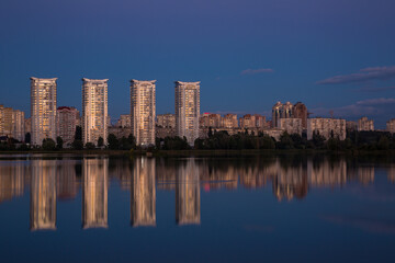 Fototapeta na wymiar Tall houses near the river, city near the river
