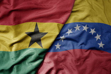 big waving national colorful flag of venezuela and national flag of ghana .