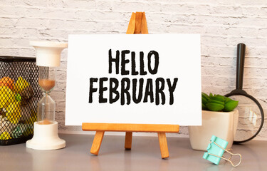 Hello February - handwriting on a napkin with a cup of coffee.