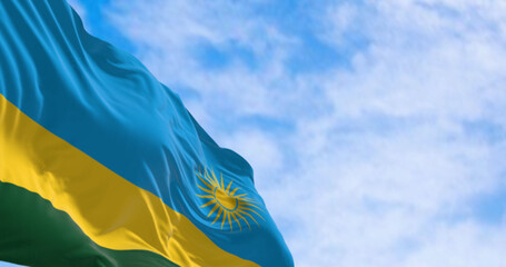 Close-up of Rwanda national flag waving on a clear day