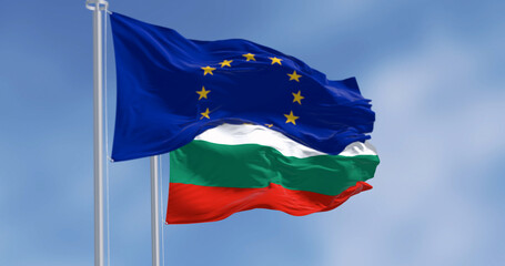 Flags of Bulgaria and the European Union waving in the wind on a clear day