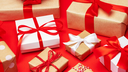 Close up shot of decorated gift boxes on bright red paper background