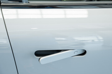 Close-up of an integrated handle in a car door. Fingerprint lock. 
