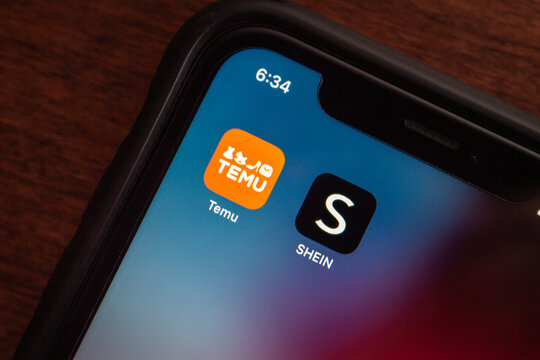 Vancouver, CANADA - Dec 25 2023 : Temu and Shein app icons seen in an iPhone.