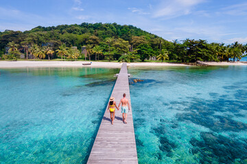 couple of men and woman walking at the beach of Koh Kham Trat Thailand