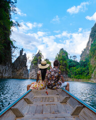 couple in longtail boat at Khao Sok Thailand, Scenic mountains on the lake in Khao Sok National Park
