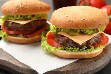 Tasty hamburgers with patties on table, closeup