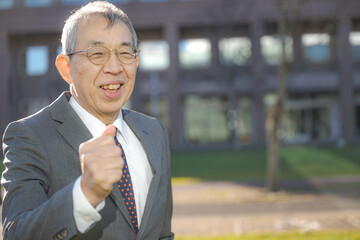 屋外でガッツポーズする男性