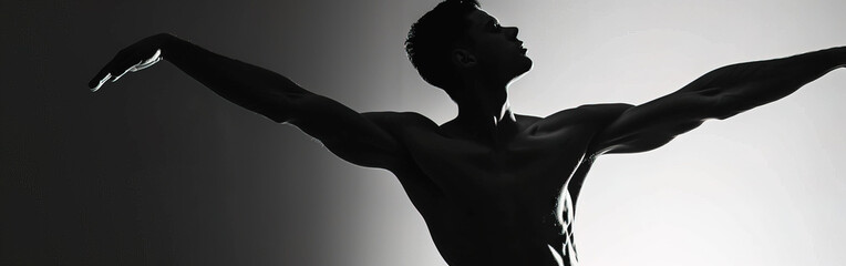 Silhouette of a male dancer performing an elegant mid-air leap on a dark stage with a dramatic...