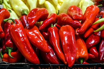 Fresh red and yellow peppers at the market. Ripe vegetables for sale.