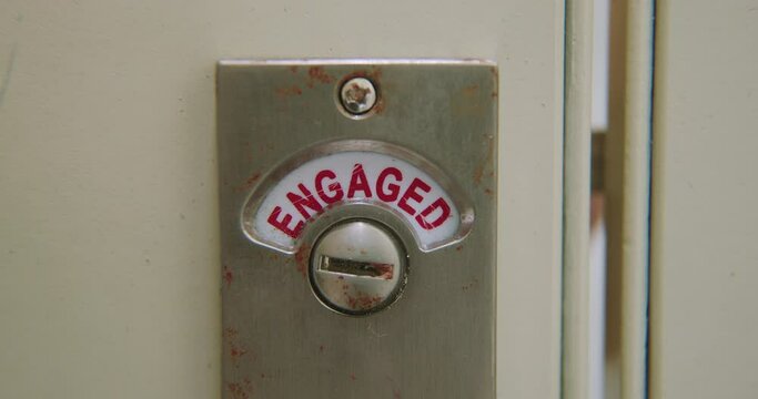 Slow Motion Close-up Of Bathroom Stall Lock Changing From 