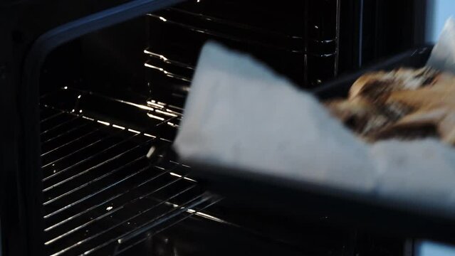 Removing Baked Festive Star-shaped Cake from the Oven: Polish Traditional Poppy Seed Roll