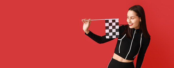 Beautiful young woman with racing flag on red background with space for text