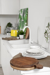 Cutting boards with plates and napkin on counter in kitchen