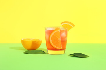 Glass of cold Negroni cocktail on color background