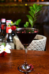 refreshing alcoholic drink with fruits, chilled vodka and gin, lemon peel served in glass tumbler
