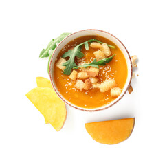 Bowl of delicious pumpkin cream soup with arugula and croutons on white background
