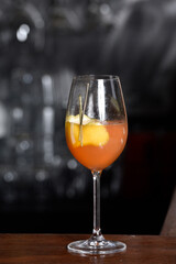 refreshing alcoholic drink with fruits, chilled vodka and gin, lemon peel served in glass tumbler