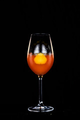 refreshing alcoholic drink with fruits, chilled vodka and gin, lemon peel served in glass tumbler