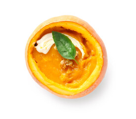 Delicious cream soup with basil and walnut in pumpkin on white background