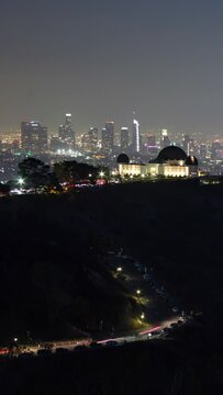 Los Angeles and Griffith Observatory city skyline at night. Vertical design in 9:16 ratio.. Smartphone and social media ready