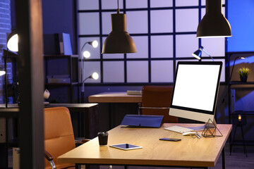 Stylish modern workplace with computer, tablet and cup of coffee in office