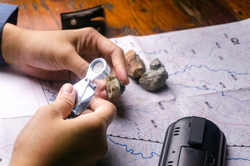 geologist using a loupe for rock and mineral identification and description
