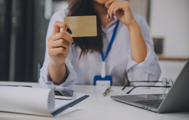 .Women holding credit card and using smartphones at home.Online shopping, internet banking, store...