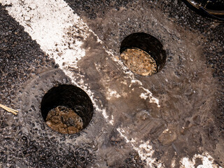 holes in asphalt roads due to core drilling
