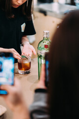 bartender pouring cocktail into bar