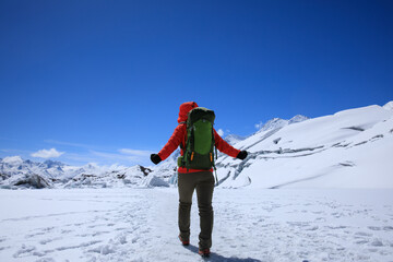 Fototapeta na wymiar Woman hiker hiking in winter huge glacier mountain,China