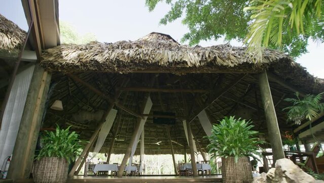 Entering old, large straw hut - wide, steady cam