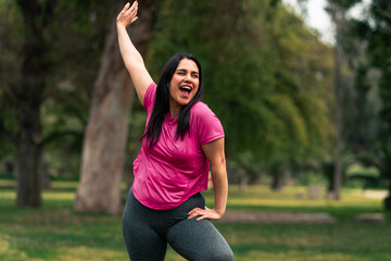 beautiful brunette latin woman enjoying and very happy after doing exercises in an outdoor park