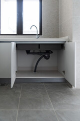 Open the cabinet under the sink